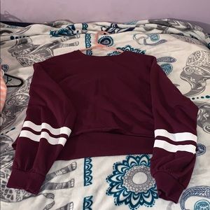 A maroon white long sleeved stripped crop top